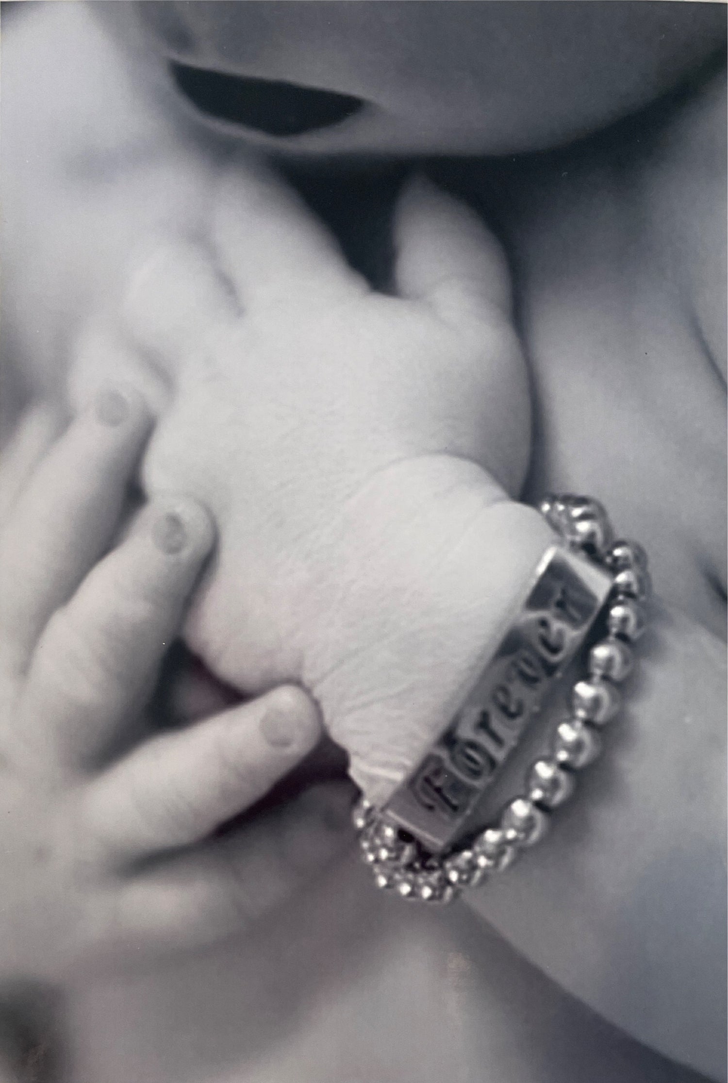 Izzyjane with her arms crossed with her forever bracelet on